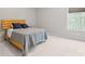 A cozy bedroom features a bed, side table, and a bright window at 240 Bells Crossing Dr, Mooresville, NC 28117