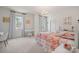 Charming bedroom with natural light, decorative chandelier, and colorful bedding at 240 Bells Crossing Dr, Mooresville, NC 28117