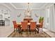 Bright dining room featuring hardwood floors, elegant lighting and decor, and a view of the kitchen at 240 Bells Crossing Dr, Mooresville, NC 28117