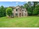 Charming two-story home with a lush green lawn and traditional architectural details at 240 Bells Crossing Dr, Mooresville, NC 28117
