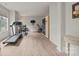 Spacious home gym with modern equipment, light wood floors, and natural light from large windows at 240 Bells Crossing Dr, Mooresville, NC 28117