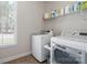 Functional laundry room with modern washer and dryer, plus ample shelving for storage at 240 Bells Crossing Dr, Mooresville, NC 28117
