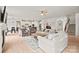 Open-concept living room with fireplace, comfortable seating, and seamless flow to the modern kitchen and dining areas at 240 Bells Crossing Dr, Mooresville, NC 28117