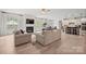 Bright and airy open-concept living room boasts hardwood floors, fireplace, and seamless flow to kitchen at 240 Bells Crossing Dr, Mooresville, NC 28117