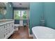 Bathroom with vanity, soaking tub, separate glass enclosed shower, and a large window at 2618 Pineview Dr, Lancaster, SC 29720