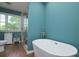 Bright bathroom featuring a modern soaking tub, wood floors, and large window at 2618 Pineview Dr, Lancaster, SC 29720