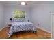 Cozy bedroom featuring wood floors, a ceiling fan, and a window with natural light at 2618 Pineview Dr, Lancaster, SC 29720