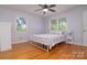Bright bedroom with hardwood floors, two windows, and a white metal bed frame at 2618 Pineview Dr, Lancaster, SC 29720