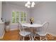 Bright dining area with a white table set, chandelier, shutters on window and hardwood floors at 2618 Pineview Dr, Lancaster, SC 29720