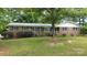 Charming brick home featuring blue shutters, lush landscaping, and a welcoming front porch at 2618 Pineview Dr, Lancaster, SC 29720