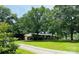 Spacious, well-maintained home with a lush green lawn and mature trees providing ample shade at 2618 Pineview Dr, Lancaster, SC 29720