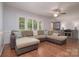 Spacious living room with large windows, ceiling fan, and comfortable sectional sofa at 2618 Pineview Dr, Lancaster, SC 29720