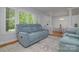 Comfortable living room featuring a plush couch, bright windows with white shutters, and sightlines to the dining room at 2618 Pineview Dr, Lancaster, SC 29720
