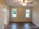 Cozy bedroom featuring two windows with backyard views and a ceiling fan at 3001 Austin Chaney Rd, Monroe, NC 28110