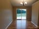 Bright dining room with sliding glass doors to a wooden deck and chandelier lighting at 3001 Austin Chaney Rd, Monroe, NC 28110