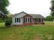 Charming home featuring a brick facade, black shutters, and a well-maintained lawn at 3001 Austin Chaney Rd, Monroe, NC 28110