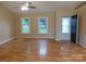 Spacious living room featuring hardwood floors, neutral paint, and natural light from multiple windows at 3001 Austin Chaney Rd, Monroe, NC 28110