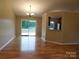 Open-concept living room with hardwood floors and access to the backyard through sliding glass doors at 3001 Austin Chaney Rd, Monroe, NC 28110