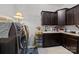 Well-equipped laundry room with modern washer and dryer, ample storage, and utility sink at 3009 Botetourt Ct, Matthews, NC 28104