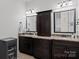 Bathroom featuring granite countertops, vanity cabinets, and mirrors at 3009 Botetourt Ct, Weddington, NC 28104