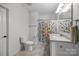Bathroom featuring a shower with patterned curtain, toilet, and vanity with storage at 3009 Botetourt Ct, Weddington, NC 28104