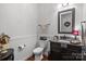 Charming powder room with wainscoting, granite vanity, decorative mirror, and stylish fixtures at 3009 Botetourt Ct, Weddington, NC 28104