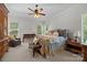 Cozy bedroom featuring a decorative ceiling fan, sitting area, and classic furnishings at 3009 Botetourt Ct, Weddington, NC 28104