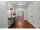 Elegant entryway with wood floors, tray ceilings, and decorative console table at 3009 Botetourt Ct, Weddington, NC 28104