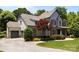 View of the house with a grey driveway, two-car garage, landscaped yard, and manicured lawn at 3009 Botetourt Ct, Weddington, NC 28104