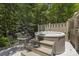 Hot tub on wooden platform with a small table, providing a relaxing backyard retreat at 3009 Botetourt Ct, Weddington, NC 28104