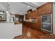 Modern kitchen with dark wood cabinets, granite countertops, stainless steel appliances, and recessed lighting at 3009 Botetourt Ct, Weddington, NC 28104
