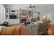 Cozy living room with a stone fireplace, built-in shelving, hardwood floors, and comfortable seating at 3009 Botetourt Ct, Weddington, NC 28104