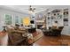 Comfortable living room featuring a stone fireplace, built-in shelves, and plush seating for relaxation at 3009 Botetourt Ct, Weddington, NC 28104