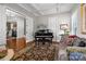Comfortable living room featuring coffered ceilings, hardwood floors, and a grand piano at 3009 Botetourt Ct, Weddington, NC 28104