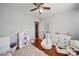 A bedroom with hardwood floors, a ceiling fan, a dresser, and a dollhouse at 3013 Coventry Commons Dr, Mint Hill, NC 28227