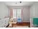 A bedroom with hardwood floors and a large teddy bear at 3013 Coventry Commons Dr, Mint Hill, NC 28227