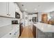 Contemporary kitchen with black appliances, white cabinets, and subway tile backsplash at 3013 Coventry Commons Dr, Mint Hill, NC 28227
