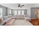 Inviting living room with a large sectional sofa, bright windows, and a ceiling fan at 3013 Coventry Commons Dr, Mint Hill, NC 28227