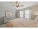 A main bedroom with neutral walls, carpet flooring, ceiling fan, and a decorative dresser with mirror at 3013 Coventry Commons Dr, Mint Hill, NC 28227