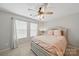 A well-lit main bedroom with neutral walls, carpet flooring, and a plush queen sized bed at 3013 Coventry Commons Dr, Mint Hill, NC 28227