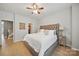 Bright main bedroom featuring hardwood floors, a plush bed, and a walk-in closet at 3013 Coventry Commons Dr, Mint Hill, NC 28227