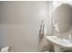 Well-lit powder room featuring a pedestal sink and round mirror at 3013 Coventry Commons Dr, Mint Hill, NC 28227