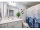 This bathroom has a modern vanity, toilet, shower/tub with a decorative geometric shower curtain at 355 Ladybird Ln, Pineville, NC 28134
