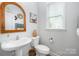 Charming powder room features a modern vanity, toilet, and decorative accents, offering a stylish and functional space at 355 Ladybird Ln, Pineville, NC 28134