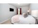 This bedroom features a plush bed, a window with curtains, a lamp, and a TV at 355 Ladybird Ln, Pineville, NC 28134