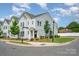 Well-manicured lawn surrounds this two-story home featuring a welcoming front porch in a vibrant neighborhood at 355 Ladybird Ln, Pineville, NC 28134