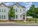 This exterior elevation shows the townhome is on a street corner with a tree in the yard at 355 Ladybird Ln, Pineville, NC 28134