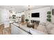 Bright, open-concept living room with stainless steel appliances, large television, and eat-in kitchen at 355 Ladybird Ln, Pineville, NC 28134