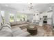 Open-concept living space featuring a cozy sectional sofa and a stylish kitchen island with barstool seating at 355 Ladybird Ln, Pineville, NC 28134