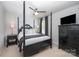 This main bedroom features a four-poster bed, side table, lamps, and a dresser with a TV at 355 Ladybird Ln, Pineville, NC 28134